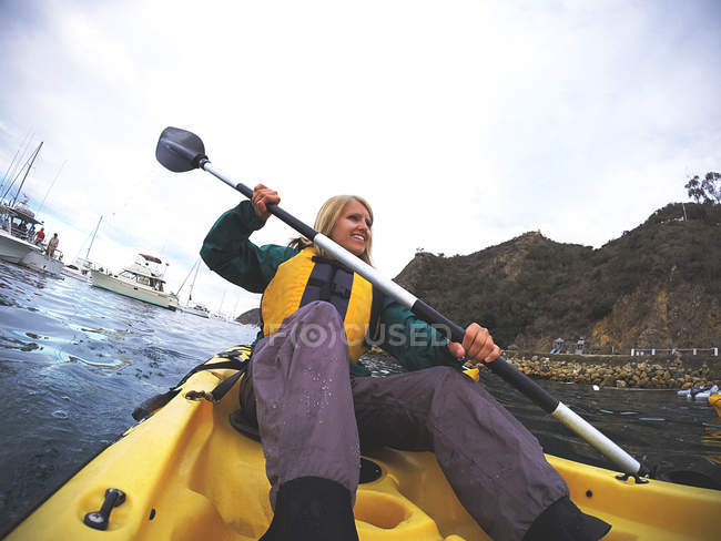 Young sporty woman kayaking — Stock Photo