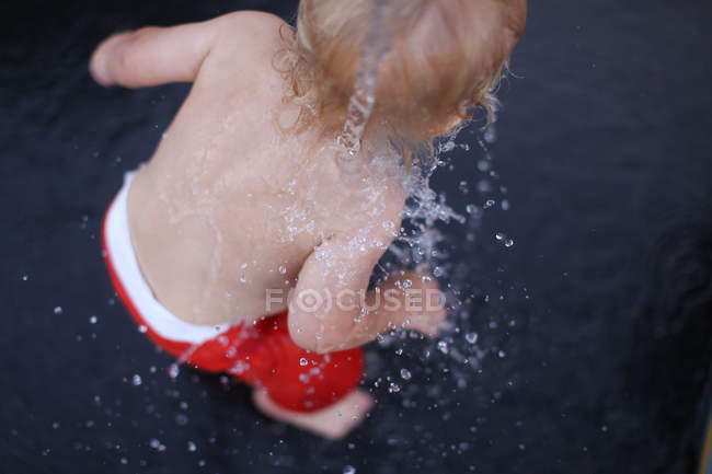 Toddler covered in water — Stock Photo