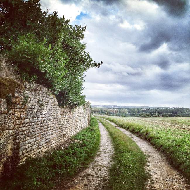 Road along ancient wall in France — Stock Photo
