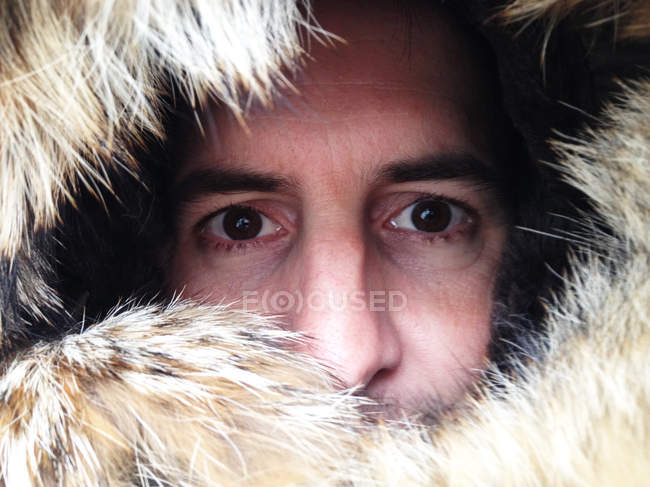 Man peering through fur hood — Stock Photo