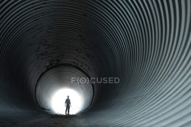 Silhouette of man in circular tunnel — Stock Photo