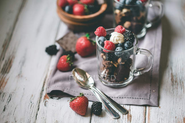 Chocolate with cakes and berries — Stock Photo