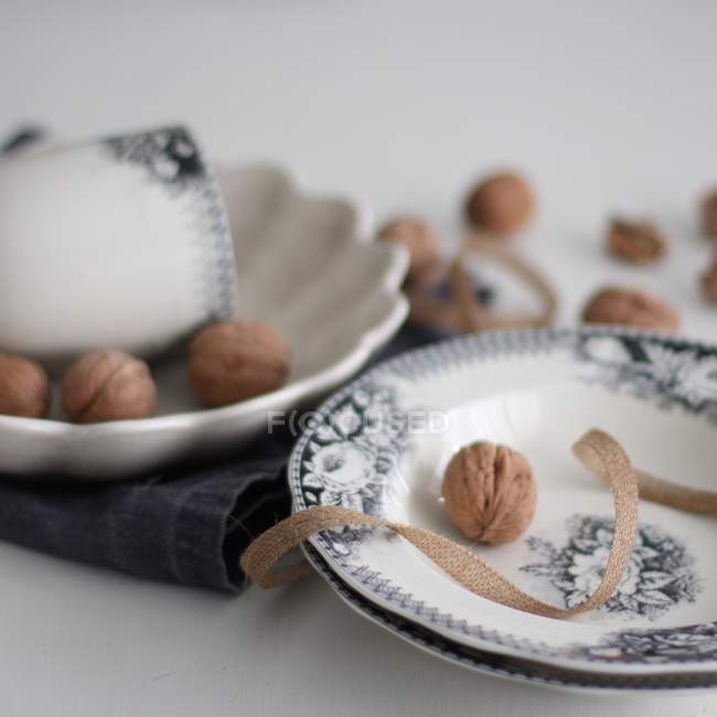 Walnuts on china plates — Stock Photo
