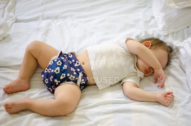Sleeping baby on bed — Stock Photo