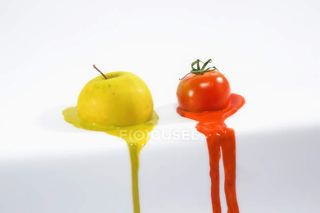 Melting apple and tomato — Stock Photo