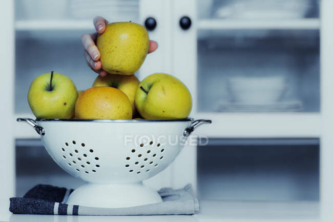 Stealing apple from kitchen — Stock Photo