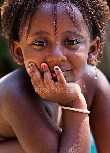 Girl with hand on chin — Stock Photo