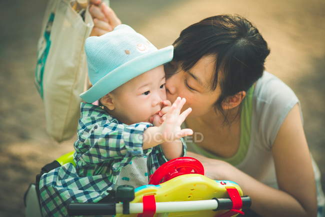 Mother kissing son — Stock Photo