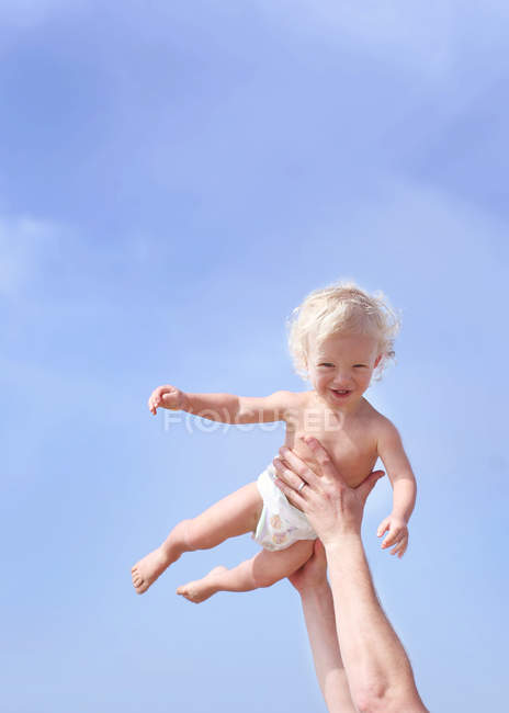 Toddler being lifted in air — Stock Photo