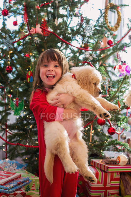 Girl hugging puppy dog — Stock Photo