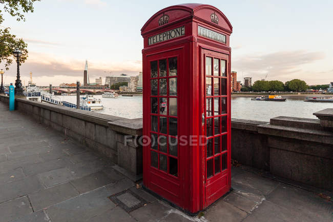 Red telephone box on quay — Stock Photo