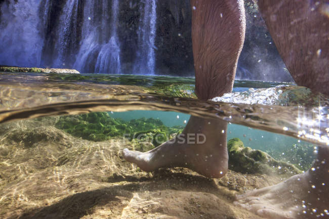 Mann geht durch klares Wasser — Stockfoto