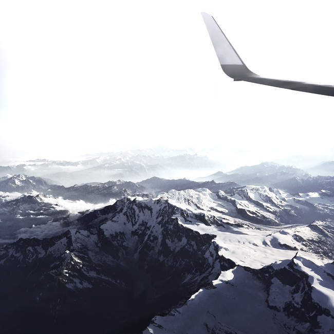 Airplane flying over alps — Stock Photo