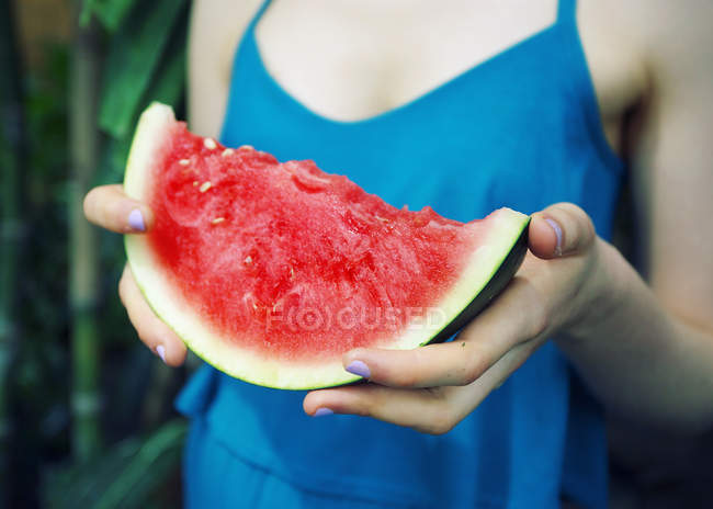 Woman holding slice of watermelon — Stock Photo