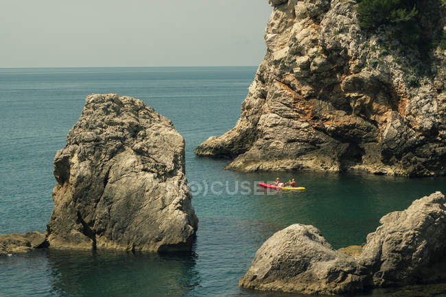 Rocks with kayak passing in between — Stock Photo
