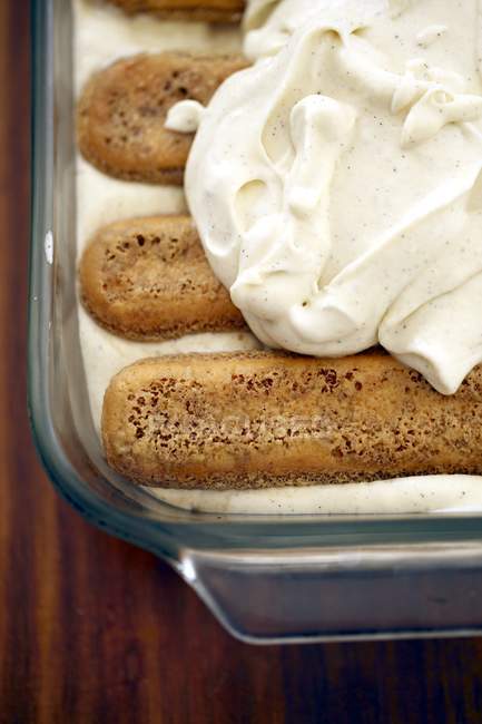 Whipped cream over tiramisu biscuits — Stock Photo