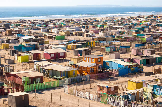 Multi colored huts on beach — Stock Photo