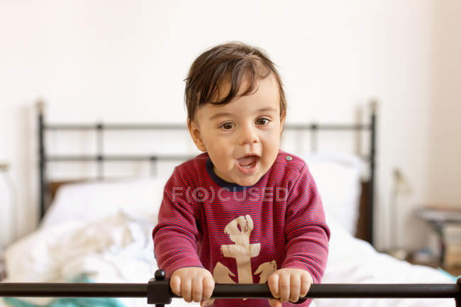 Junge spielt auf einem Bett — Stockfoto