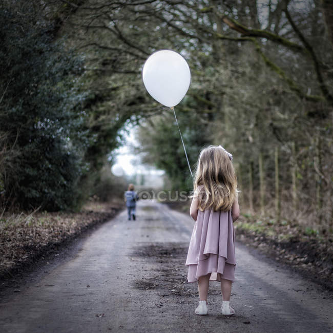 Girl holding a balloon — Stock Photo