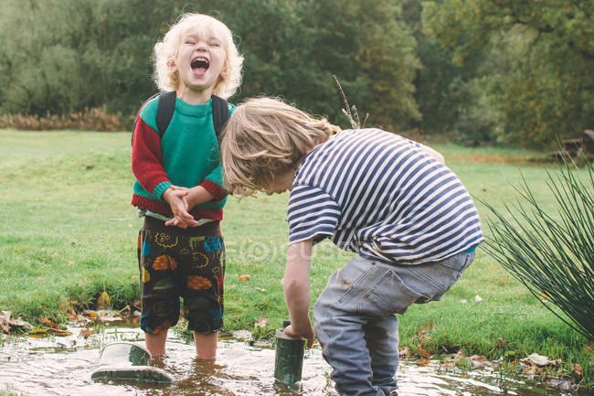 Children having fun in puddle — Stock Photo