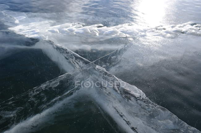 Frozen cross shape in ice — Stock Photo