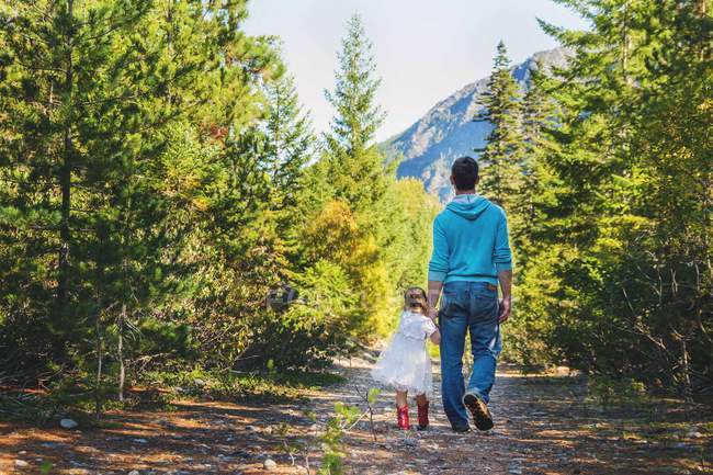 Pai e filha caminhando na floresta — Fotografia de Stock