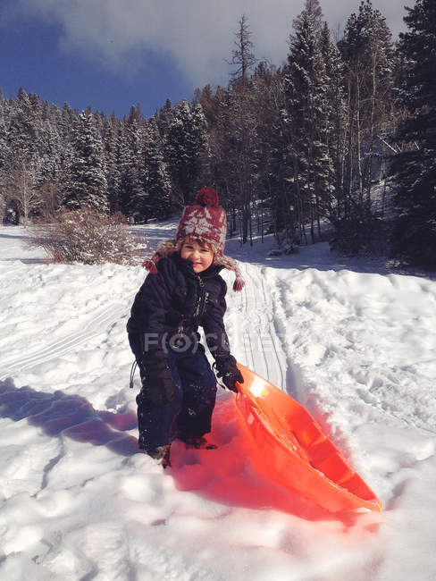Boy holding sledge — Stock Photo