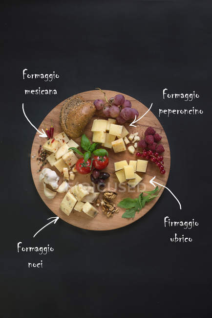 Italian cheese on chopping board — Stock Photo