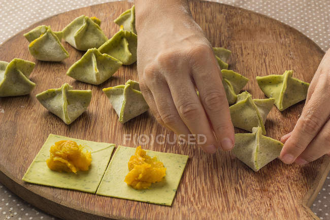 Woman preparing stuffed pumpkin pasta — Stock Photo