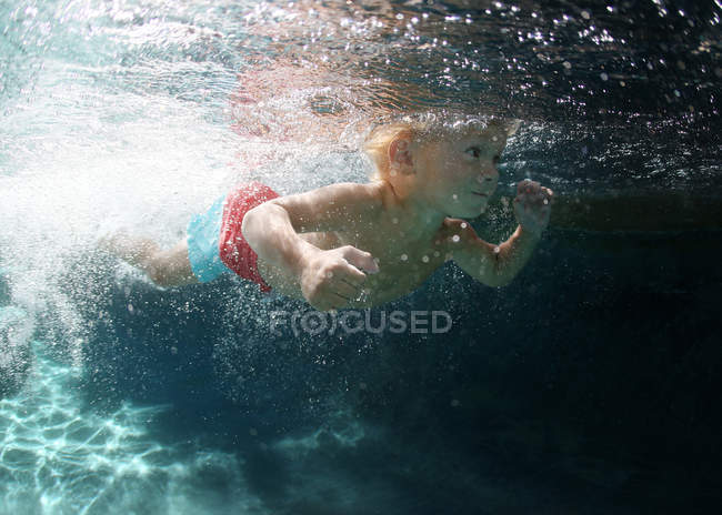 Little baby swimming in pool — Stock Photo