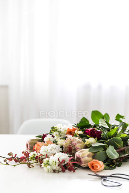 Bunch of Flowers lying on table — Stock Photo