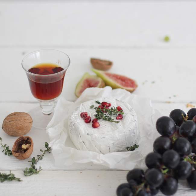 Camembert cheese, fruits and nuts — Stock Photo