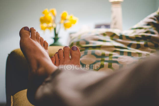 Woman relaxing on couch — Stock Photo