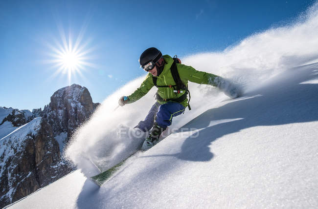 Человек катается на лыжах с трассы — стоковое фото