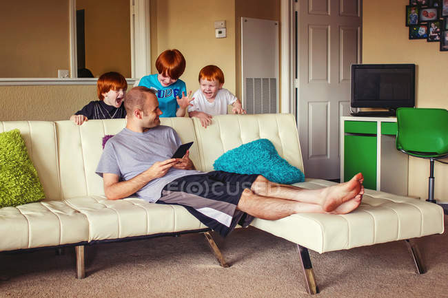 Boys trying to surprise their father — Stock Photo