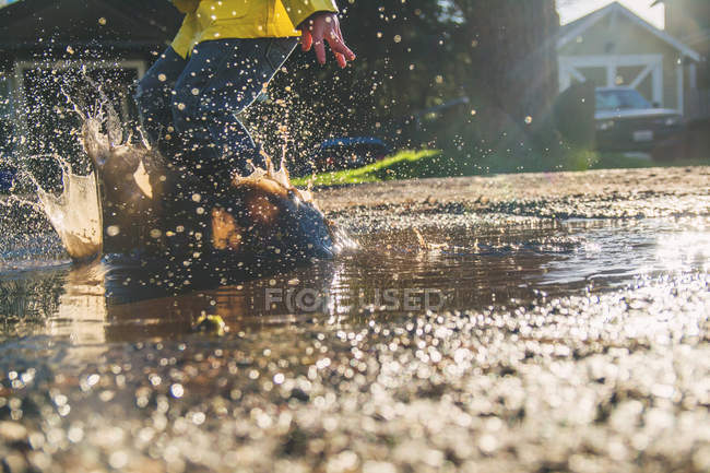 Boy jumping in water — Stock Photo