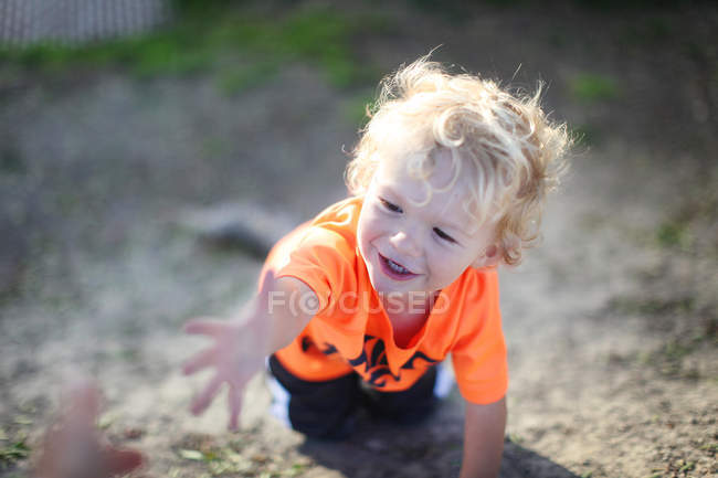 Smiling boy on all fours — Stock Photo