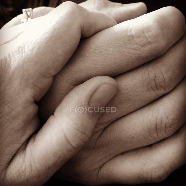 Little hand holding bigger hand — Stock Photo