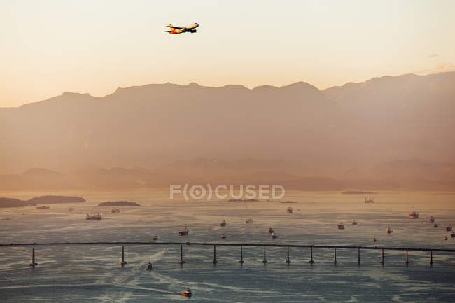 Airplane flying over river — Stock Photo