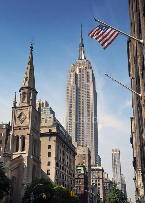 American flag and empire state building — Stock Photo