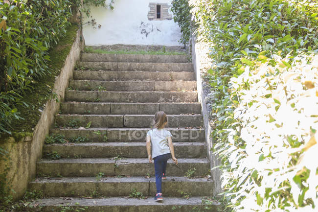 Girl walking up steps — Stock Photo