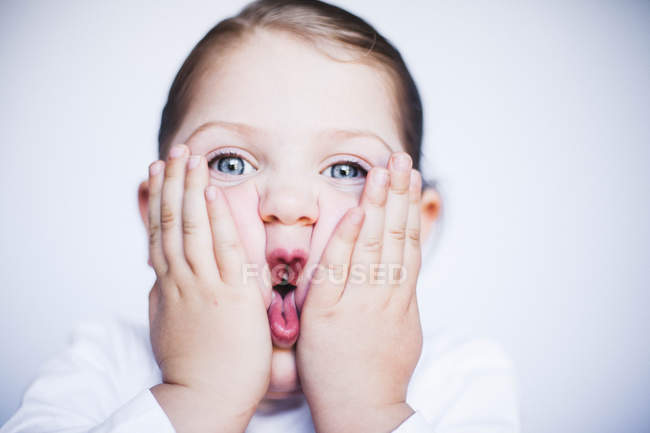 Girl squashing her cheeks — Stock Photo