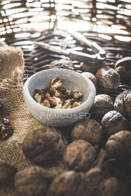 Breaking walnuts in bowl — Stock Photo