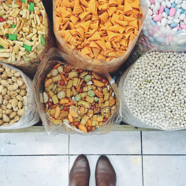 Feet  in front of snacks — Stock Photo