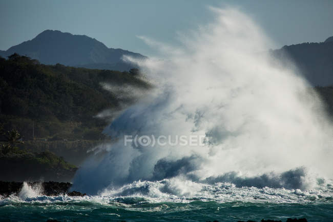 Океанська вода стискається над скелями — стокове фото