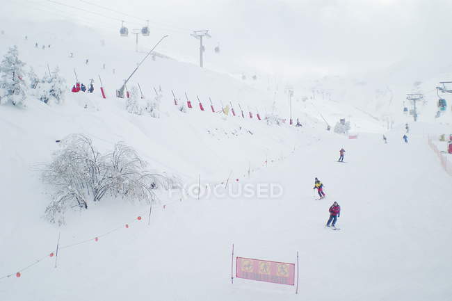 People skiing down ski slope — Stock Photo