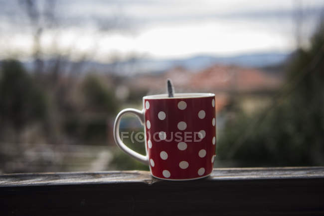 Cup of tea on window sill — Stock Photo