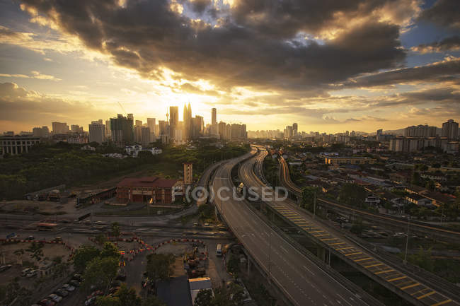 Road through city at sunset — Stock Photo