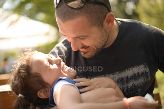 Father tickling daughter — Stock Photo