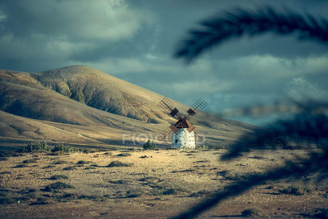 Windmill on filed over hills — Stock Photo
